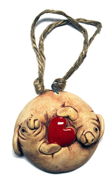 A handcrafted manatee heart ornament is included with adoptions of $35 or more.