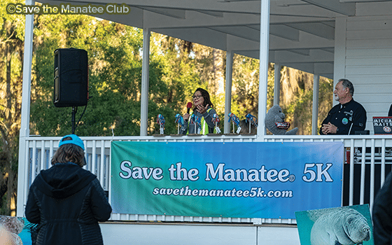 Former race director Lesley Argiri and SMC Executive Director Patrick Rose welcome runners to the Save the Manatee 5K at Blue Spring State Park.