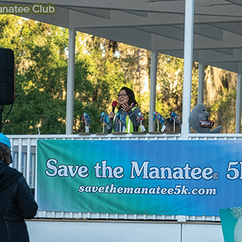 Former race director Lesley Argiri and SMC Executive Director Patrick Rose welcome runners to the Save the Manatee 5K at Blue Spring State Park.