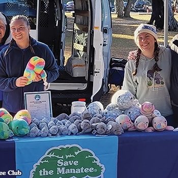 Volunteers Peggy and Hannah with staff members Stephanie and Gina setting up at the Orange City Blue Spring Manatee Festival. Photo by Save the Manatee Club.