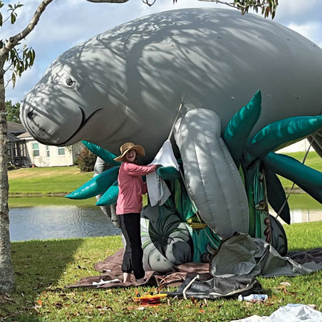 Volunteer Specialist Gina bathes Hope, the inflatable manatee.
Photo courtesy of Chris McGrath.
