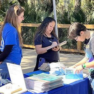 Save the Manatee Club volunteers at the 2025  Orange City Blue Spring Manatee Festival speak with and assist visitors interested in learning about manatees.