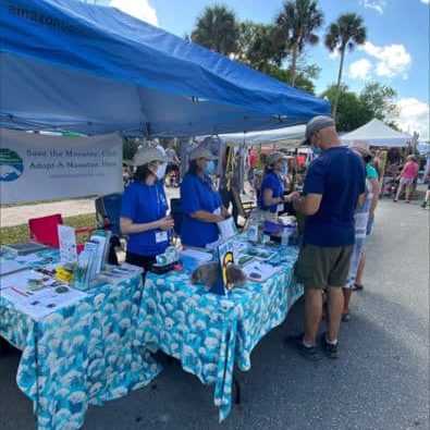 Volunteers Audrey, Melissa, and Chelsea talked to event visitors about the threats that manatees face in the wild and ways that people can help.